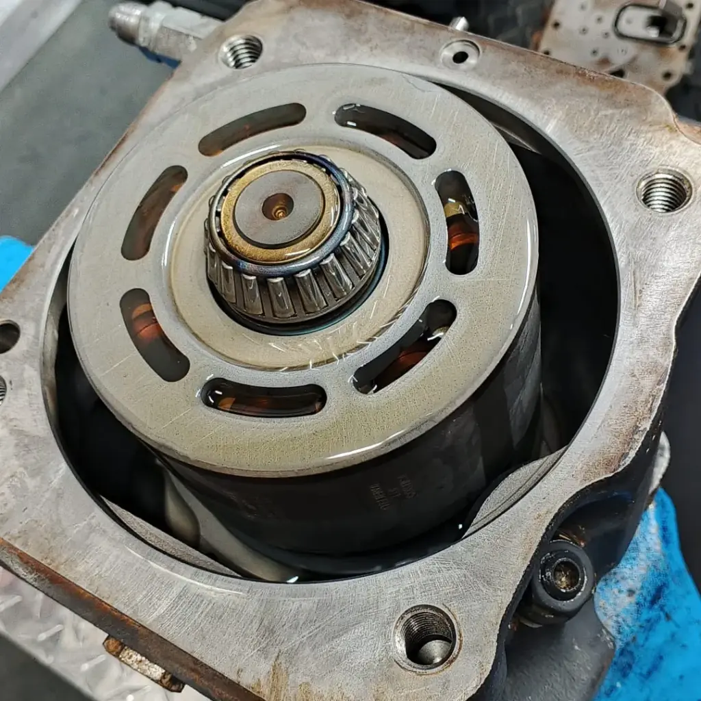 Pompă hidraulică Komatsu WB93 desfăcută, văzută de sus: grupul rotativ cu rulmentul central în carcasă